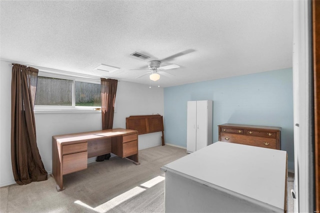 bedroom with visible vents, a textured ceiling, light colored carpet, and a ceiling fan