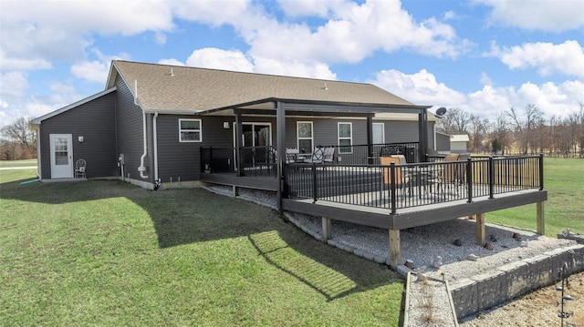 rear view of property with a deck and a lawn