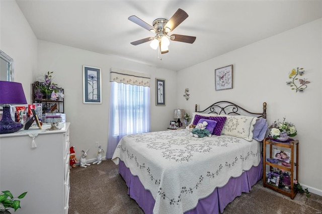 carpeted bedroom featuring baseboards and ceiling fan