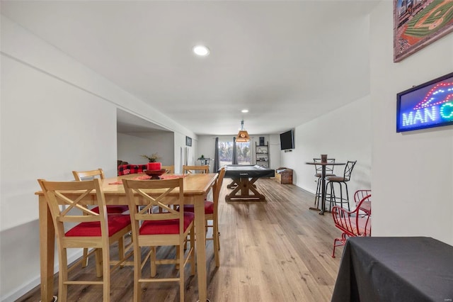 dining space with recessed lighting, baseboards, and wood finished floors