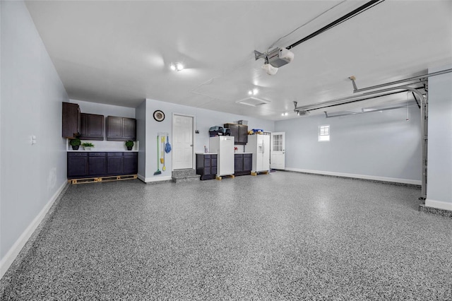 garage featuring a garage door opener, baseboards, and freestanding refrigerator