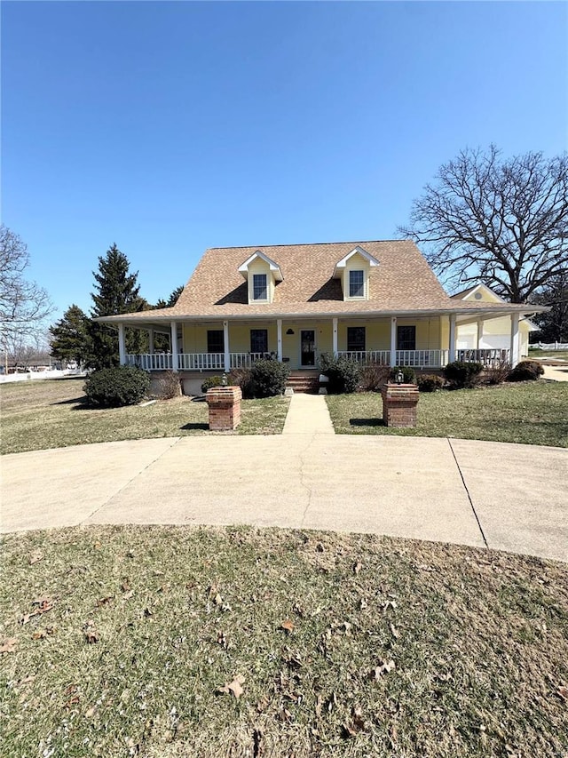 view of front of house with covered porch and a front lawn