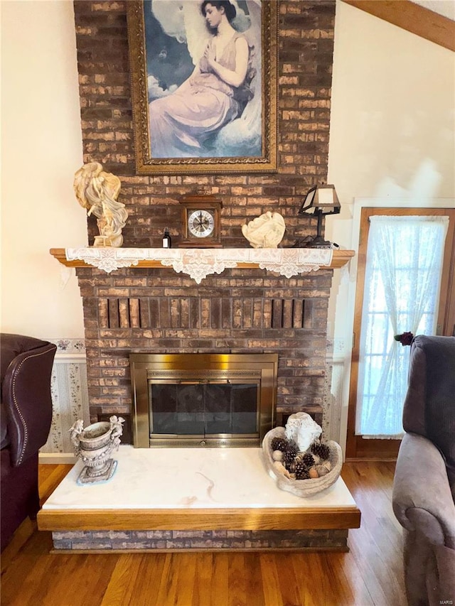 details featuring wood finished floors and a fireplace