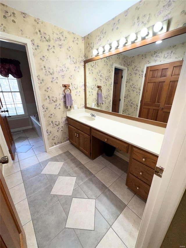 full bathroom with tile patterned flooring, wallpapered walls, vanity, and baseboards