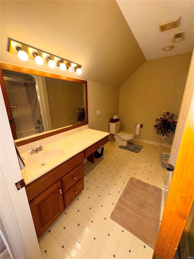 bathroom with a shower with door, visible vents, vaulted ceiling, tile patterned floors, and vanity