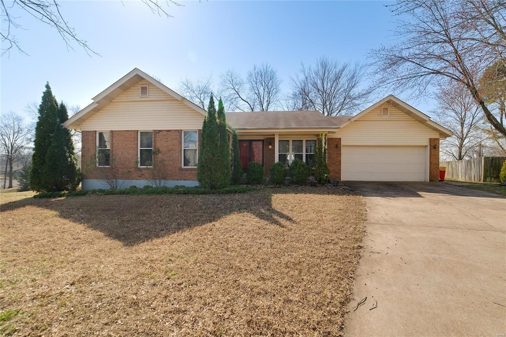 ranch-style home with brick siding, driveway, a garage, and fence