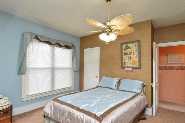 bedroom featuring baseboards, light carpet, ceiling fan, and wallpapered walls