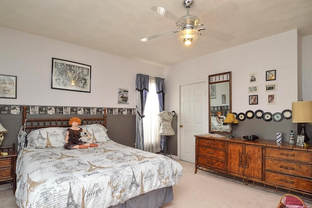 bedroom with light carpet and a ceiling fan