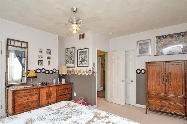 bedroom with a ceiling fan, baseboards, visible vents, and light carpet