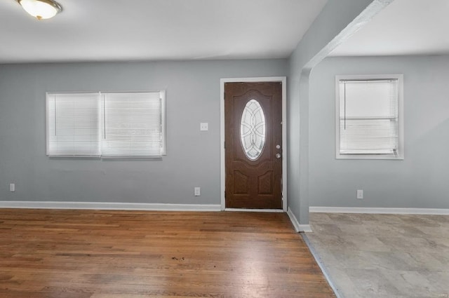 foyer with baseboards and wood finished floors