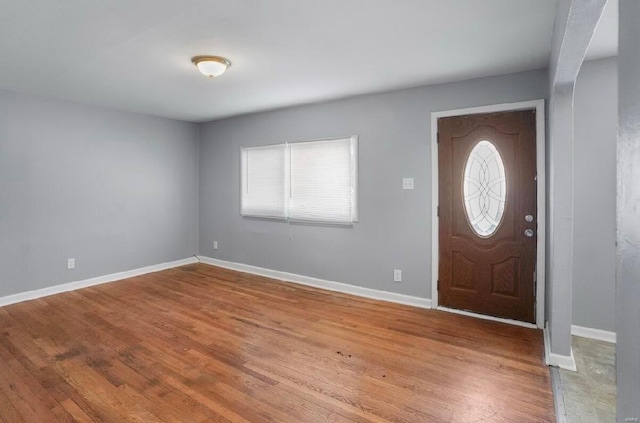 entrance foyer featuring a wealth of natural light, baseboards, and wood finished floors