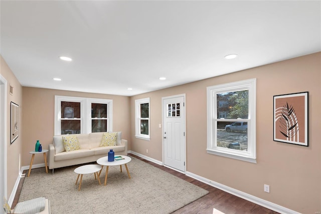 living room with visible vents, recessed lighting, baseboards, and wood finished floors