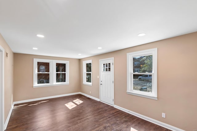 foyer with visible vents, recessed lighting, dark wood-type flooring, and baseboards