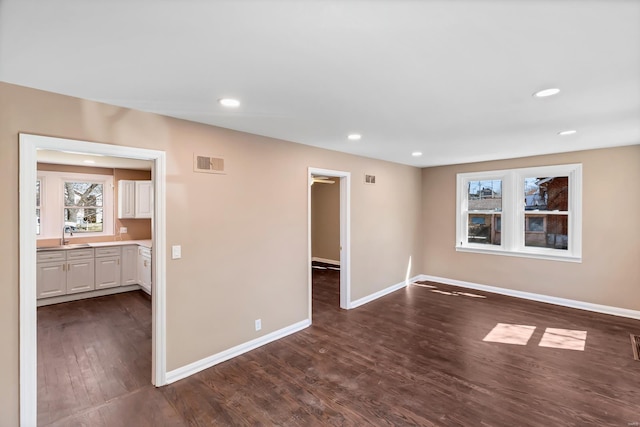 unfurnished room featuring visible vents, recessed lighting, baseboards, and dark wood-style flooring