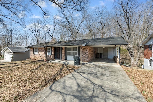 ranch-style house featuring brick siding, an attached carport, and driveway