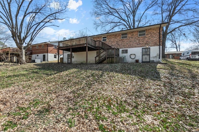 rear view of property featuring a deck and stairway