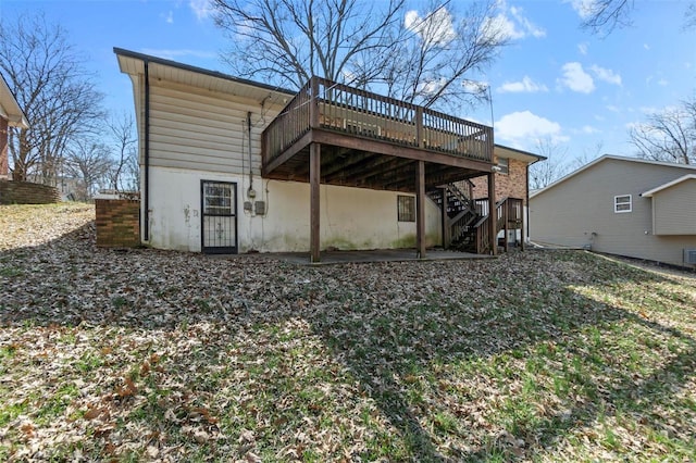 back of property with stairway and a deck