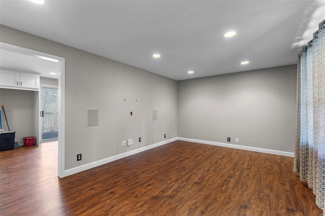 spare room featuring recessed lighting, baseboards, and dark wood-style flooring