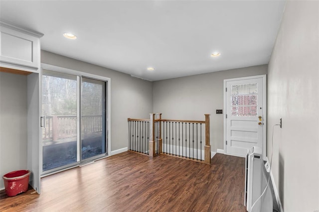 unfurnished room with recessed lighting, baseboards, and wood finished floors