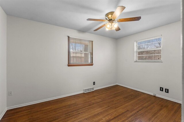 empty room with a healthy amount of sunlight, baseboards, a ceiling fan, and wood finished floors