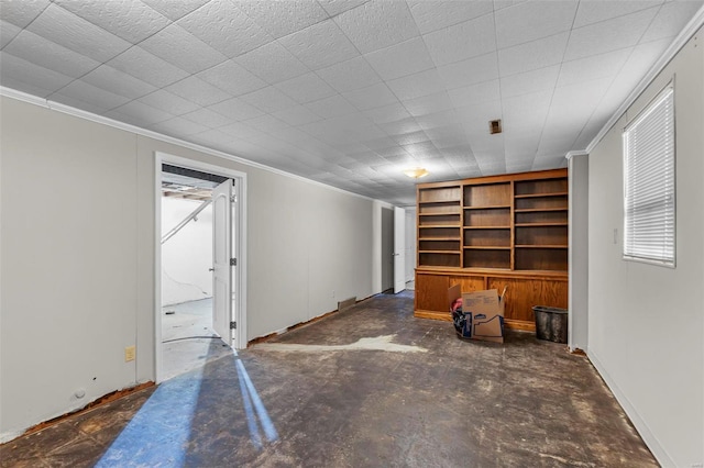 living room with concrete floors and ornamental molding