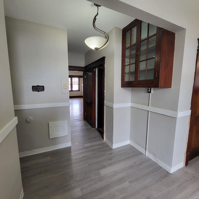 hallway with wood finished floors and baseboards