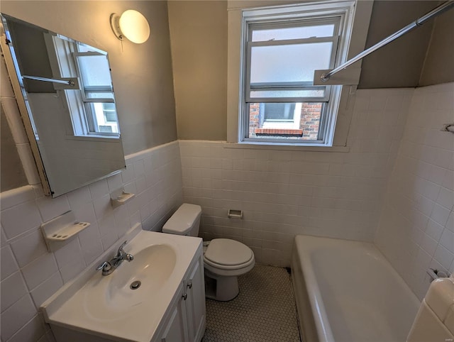 bathroom with tile patterned floors, plenty of natural light, toilet, and vanity