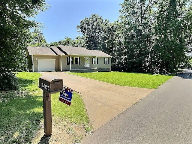 view of front of home featuring a garage, driveway, and a front yard