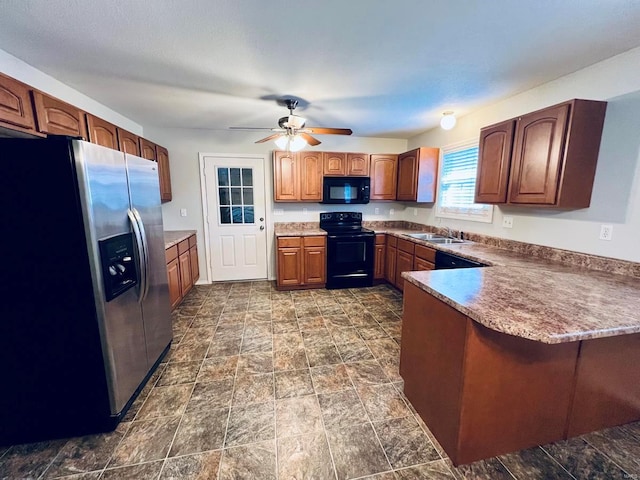 kitchen featuring black appliances, a ceiling fan, a sink, a peninsula, and brown cabinetry