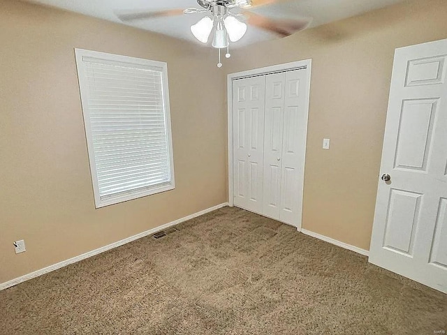 unfurnished bedroom with carpet flooring, baseboards, visible vents, and a closet