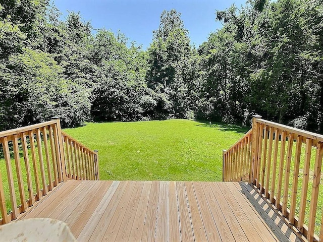 wooden deck with a lawn