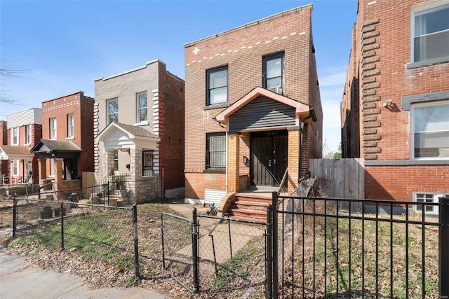 view of front of home featuring a fenced front yard and brick siding