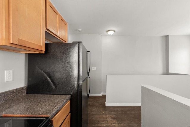 kitchen featuring electric range, baseboards, freestanding refrigerator, and dark wood-type flooring