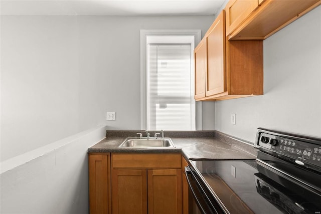 kitchen with dark countertops, black electric range oven, and a sink