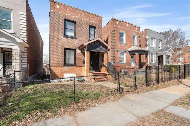 view of front of home featuring a fenced front yard and brick siding