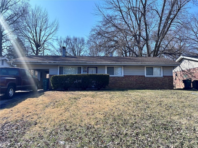 single story home with a front yard and brick siding