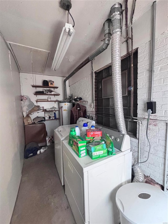 washroom featuring washing machine and clothes dryer, laundry area, gas water heater, and attic access