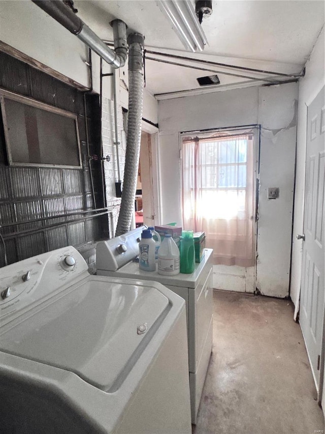 laundry room featuring separate washer and dryer and laundry area