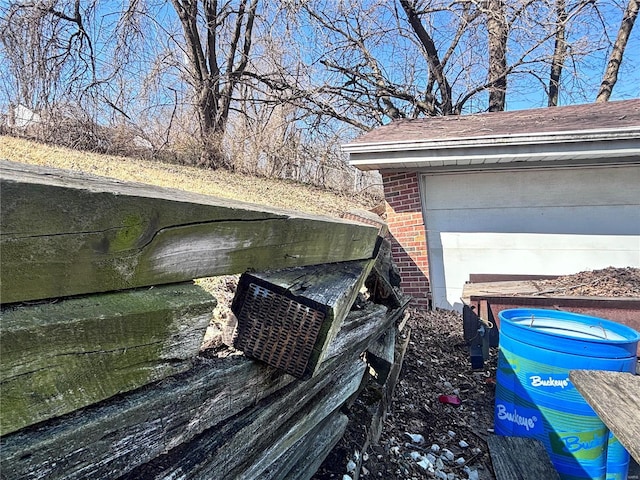 exterior details with brick siding and a shingled roof