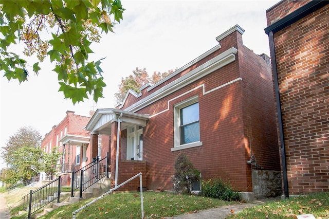 view of side of property with brick siding