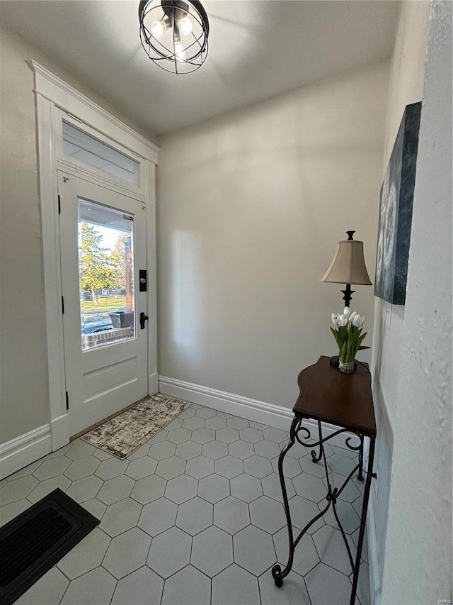 entryway with tile patterned floors and baseboards