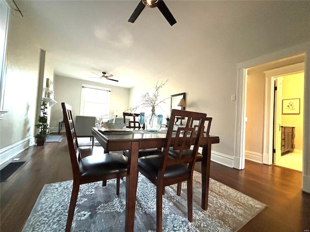 dining area with baseboards, a ceiling fan, and wood finished floors