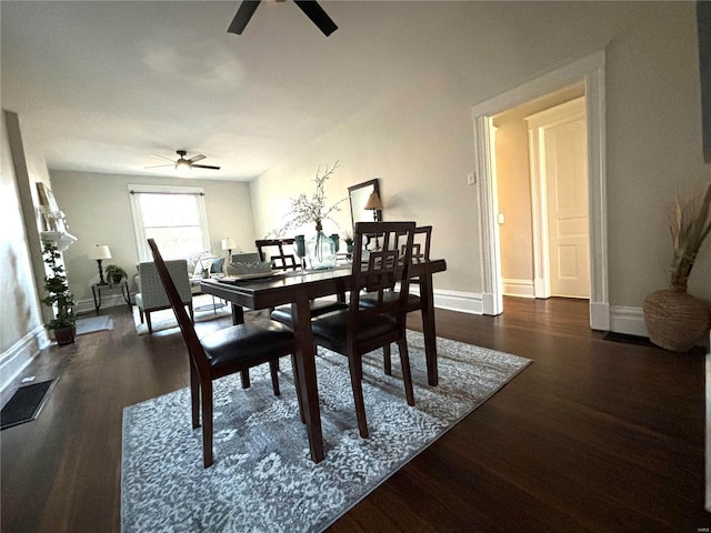 dining space featuring visible vents, baseboards, wood finished floors, and a ceiling fan