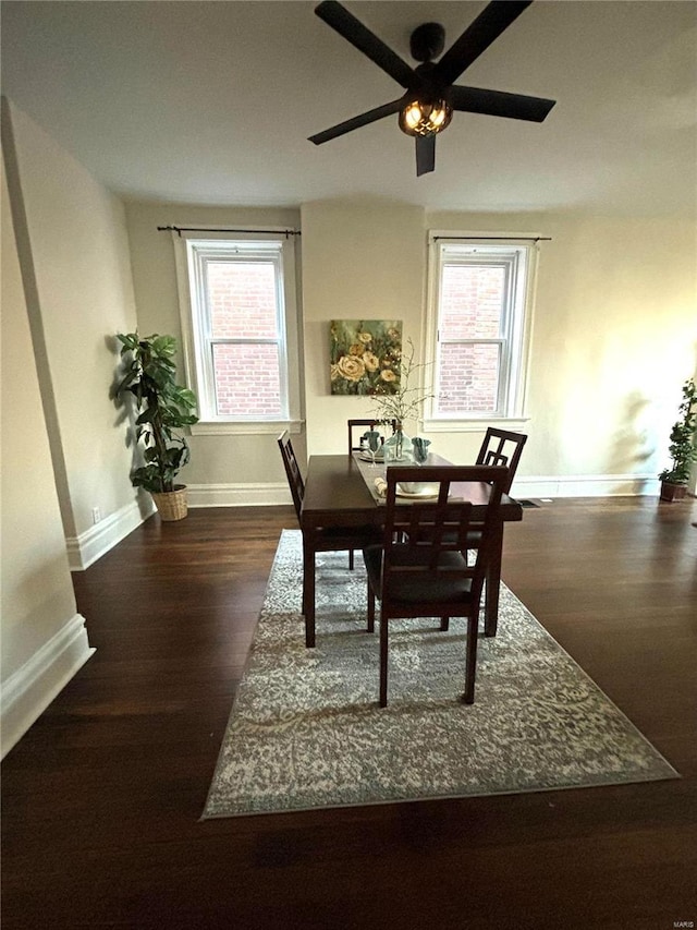 dining space with a healthy amount of sunlight, baseboards, and wood finished floors