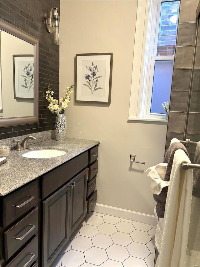 full bathroom with backsplash, vanity, and baseboards