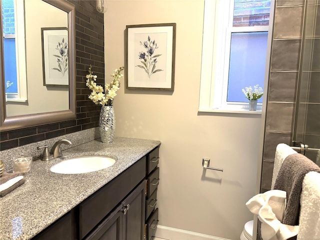 bathroom featuring vanity and tasteful backsplash