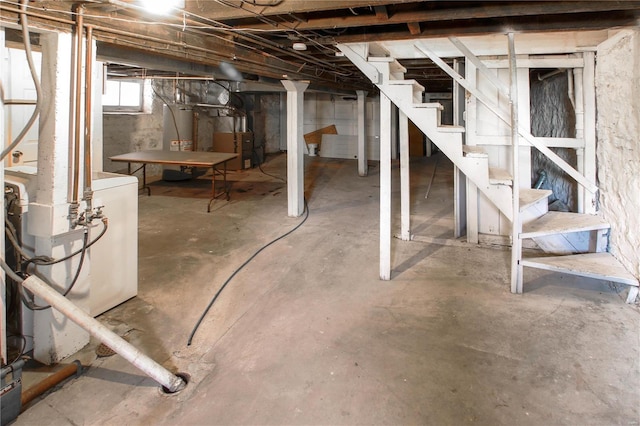 below grade area featuring gas water heater, stairway, and heating unit