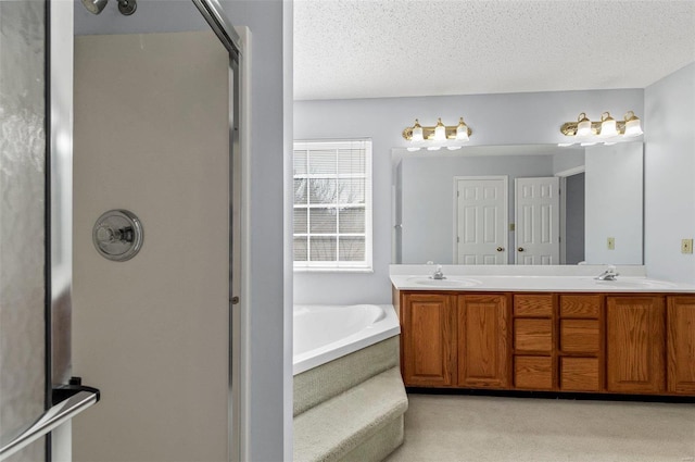 bathroom with double vanity, a bath, an enclosed shower, a textured ceiling, and a sink