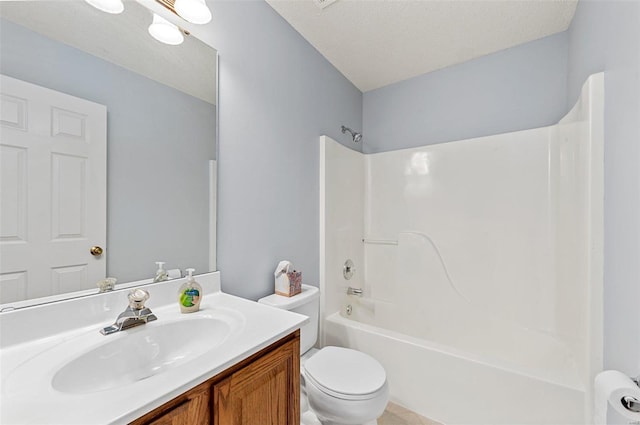 bathroom with tub / shower combination, toilet, vanity, and a textured ceiling