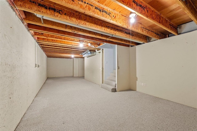 finished basement with stairway and carpet